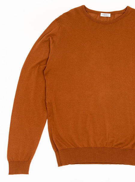 Flat lay of men's ginger/burnt orange long sleeve crewneck sweater knit in a luxury and premium 100% merino wool.